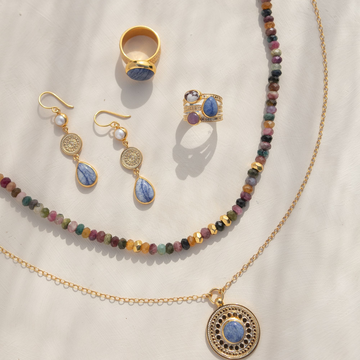 Picture of beautiful gold jewellery featuring hand dotted metal and different natural stones. 