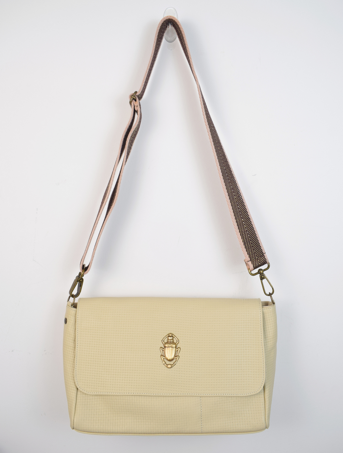 beige bag with gold scarab detail