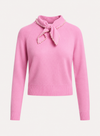 A pink knit sweater with a high folded collar, a matching bow at the neck, and a border of small pearl-like embellishments. The sweater has long sleeves with ribbed cuffs and a ribbed hem, shown against a plain light background.