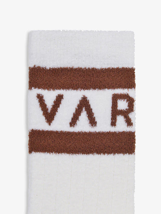 white socks with brown varley logo close up