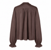 A dark brown long-sleeve blouse with a gathered, pleated back design, ruffled trim at the collar, and ruffled cuffs, shown against a plain white background.