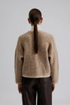 Biscuit coloured round neck cardigan with long sleeves and gold toned buttons rear view