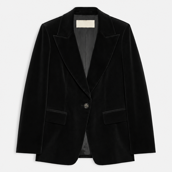 A black velvet blazer jacket with notched lapels and a single button closure, displayed flat against a light gray background.