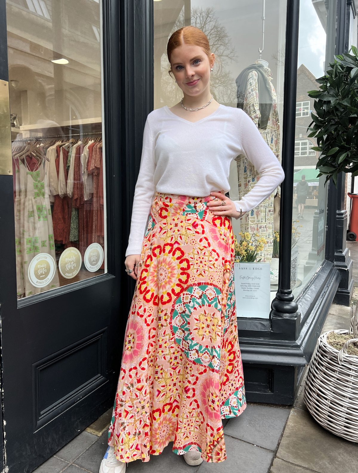 Patterned maxi skirt in tones of pink and turquoise with a shaped hem detail