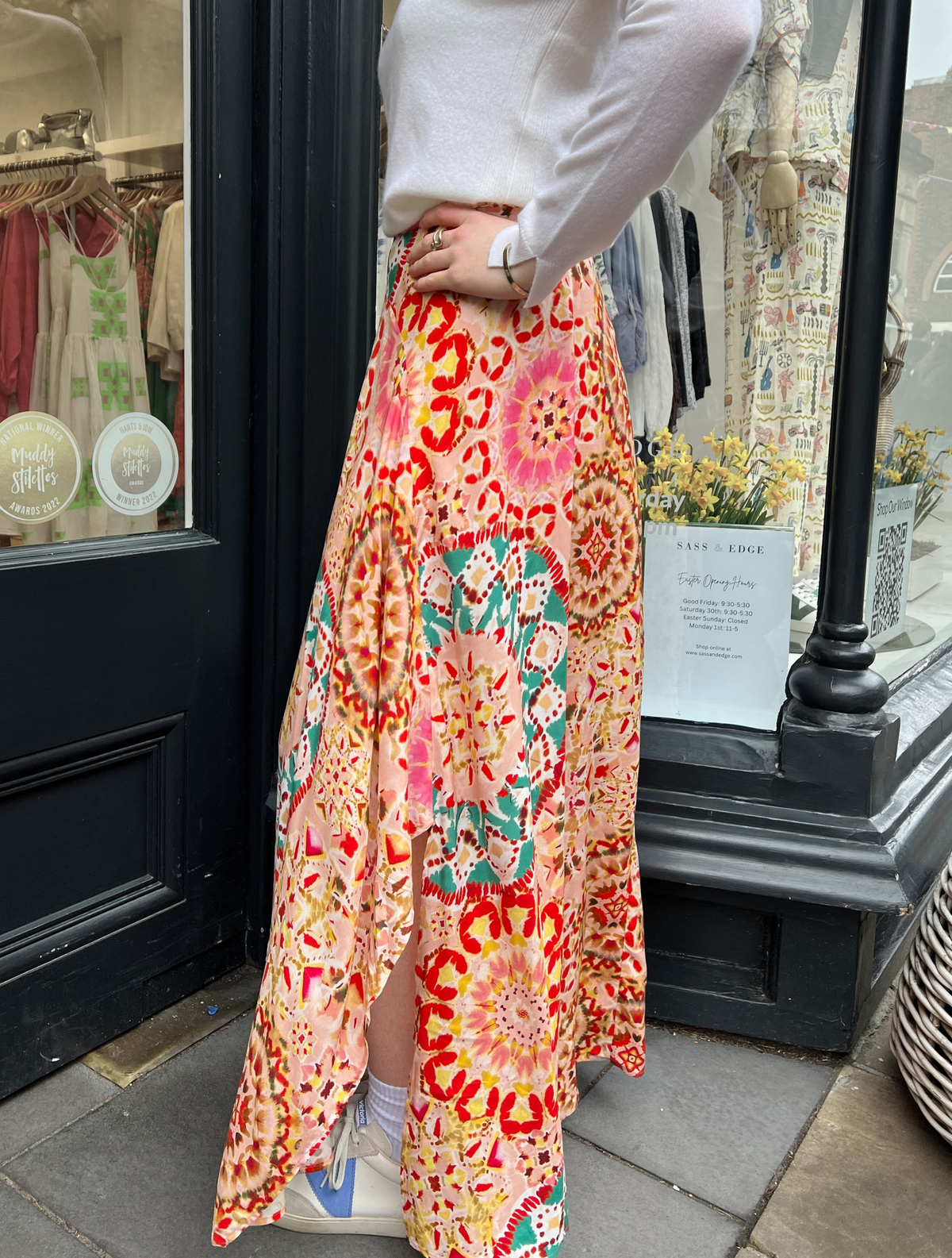 Patterned maxi skirt in tones of pink and turquoise with a shaped hem detail