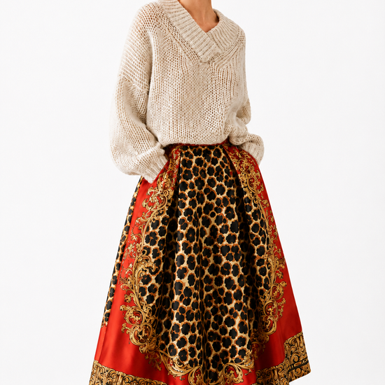 model wearing a red and leopard print skirt with a beige knit on a white background 