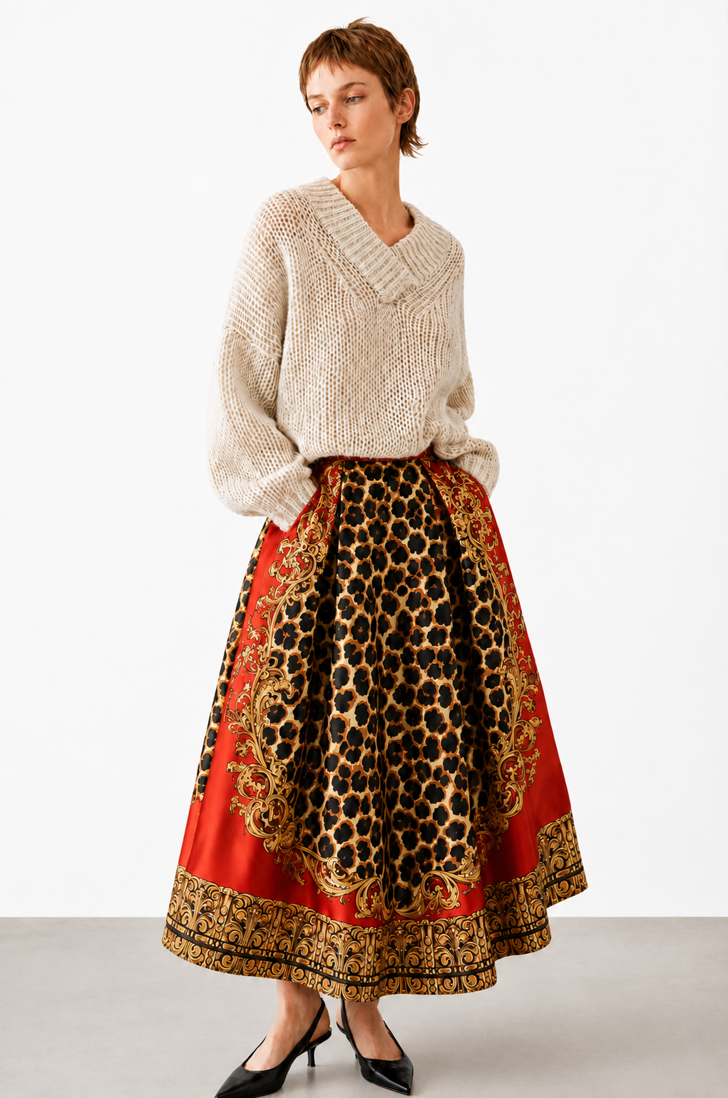 model wearing a red and leopard print skirt with a beige knit on a white background 