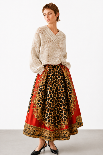 model wearing a red and leopard print skirt with a beige knit on a white background 