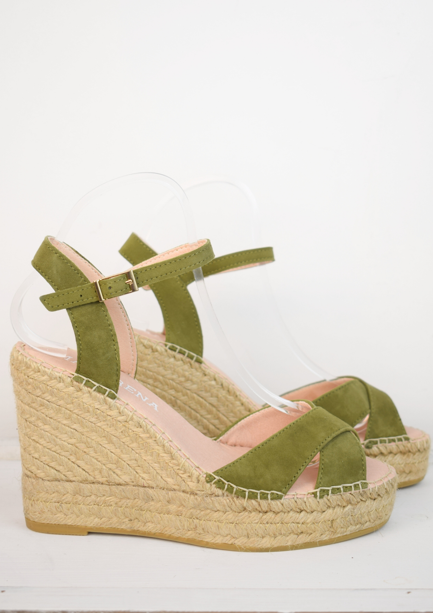 Wedge sandals with a green cross cover on the toes