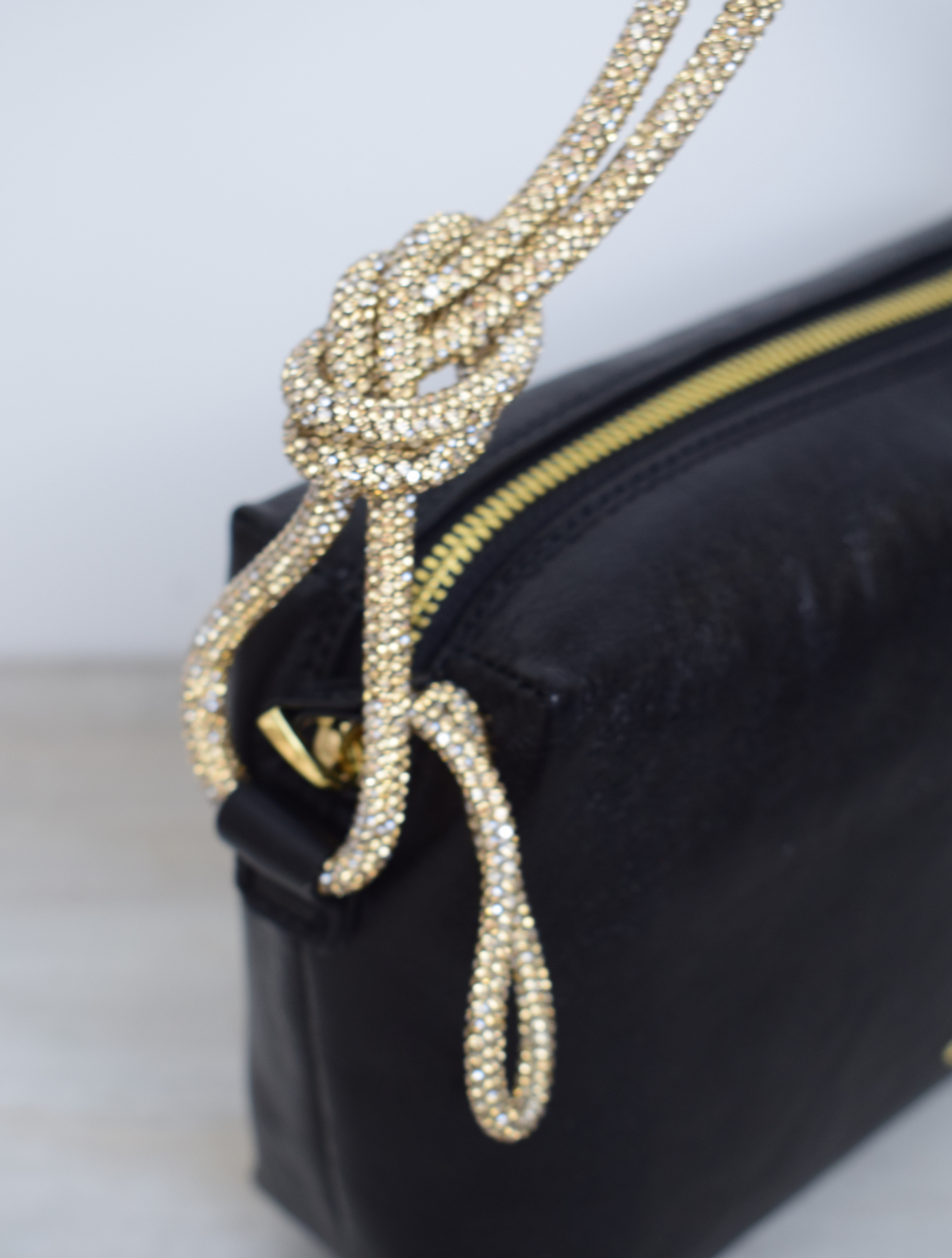 Black bag with gold rope handle