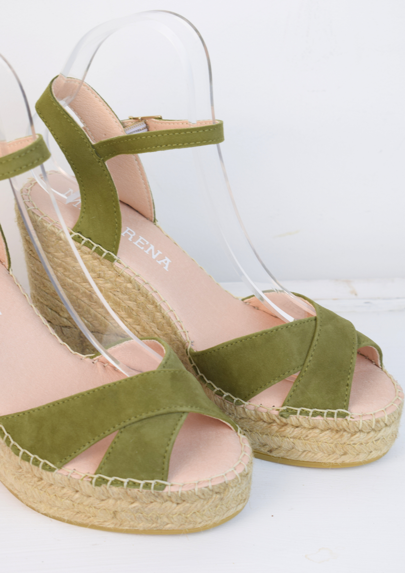 Wedge sandals with a green cross cover on the toes