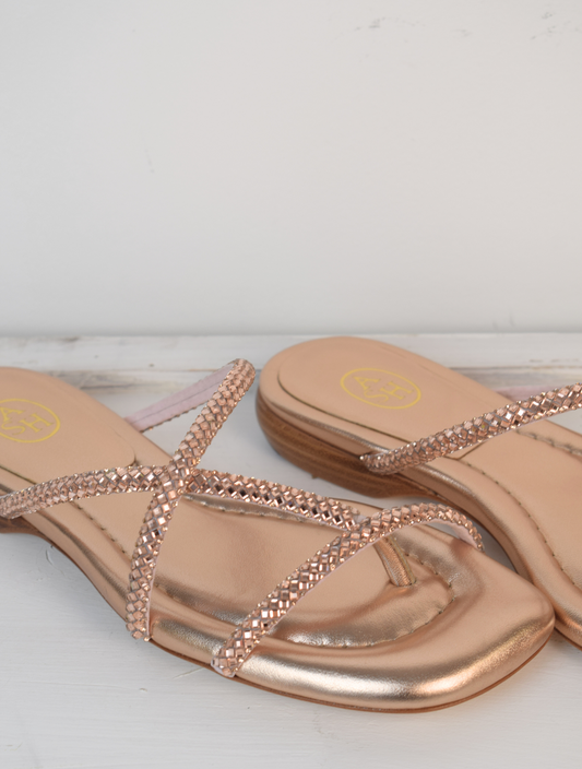 Slider style sandal in a rose gold colour with dominates on the top