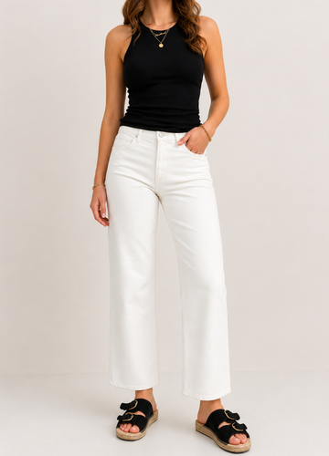 model wearing white jeans on plain background 