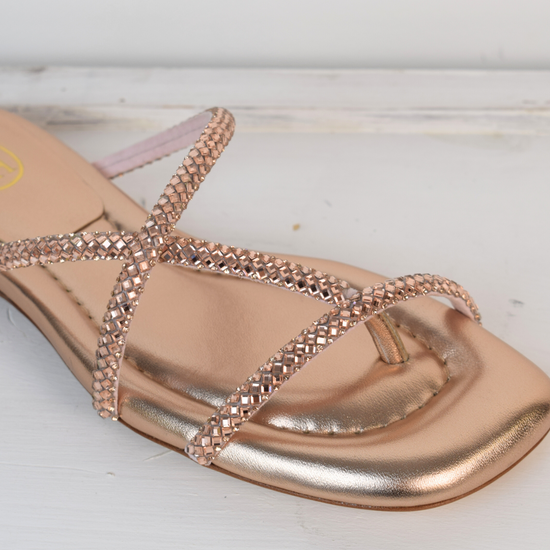 Slider style sandal in a rose gold colour with dominates on the top