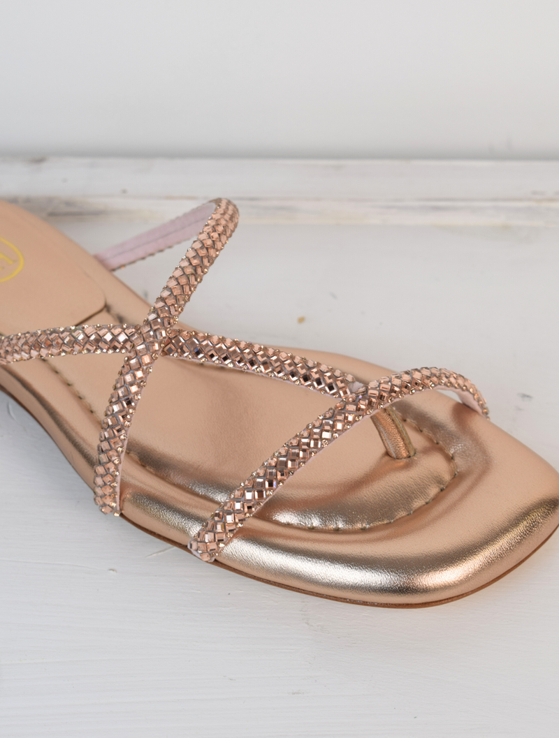 Slider style sandal in a rose gold colour with dominates on the top