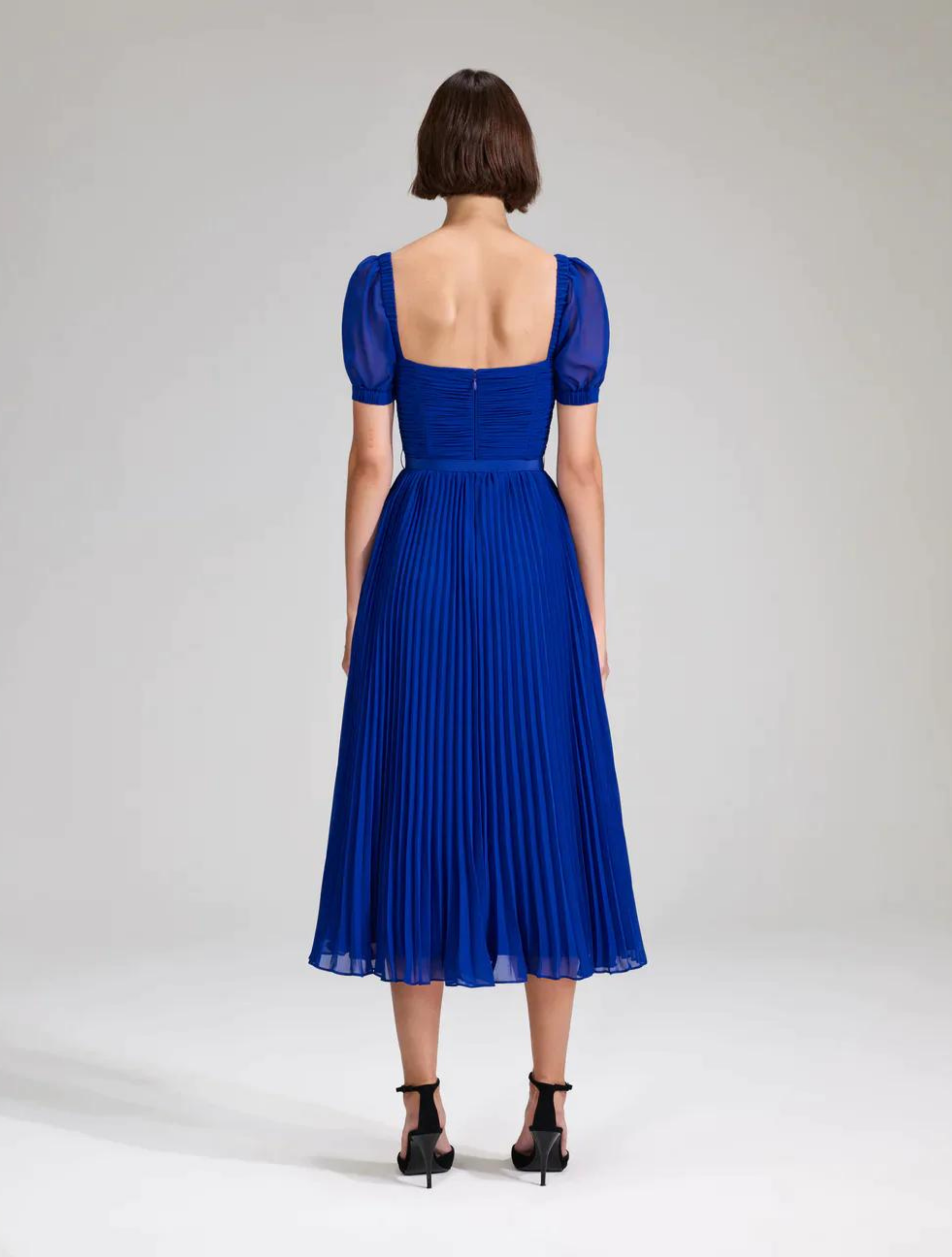 Cobalt blue midi dress with twisted pleated fitted bodice, short sleeves and a pleated midi skirt