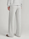 A person shown from the back wearing light heather gray wide-leg sweatpants and a matching sweatshirt, photographed against a plain light gray studio background.