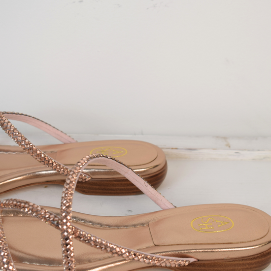 Slider style sandal in a rose gold colour with dominates on the top