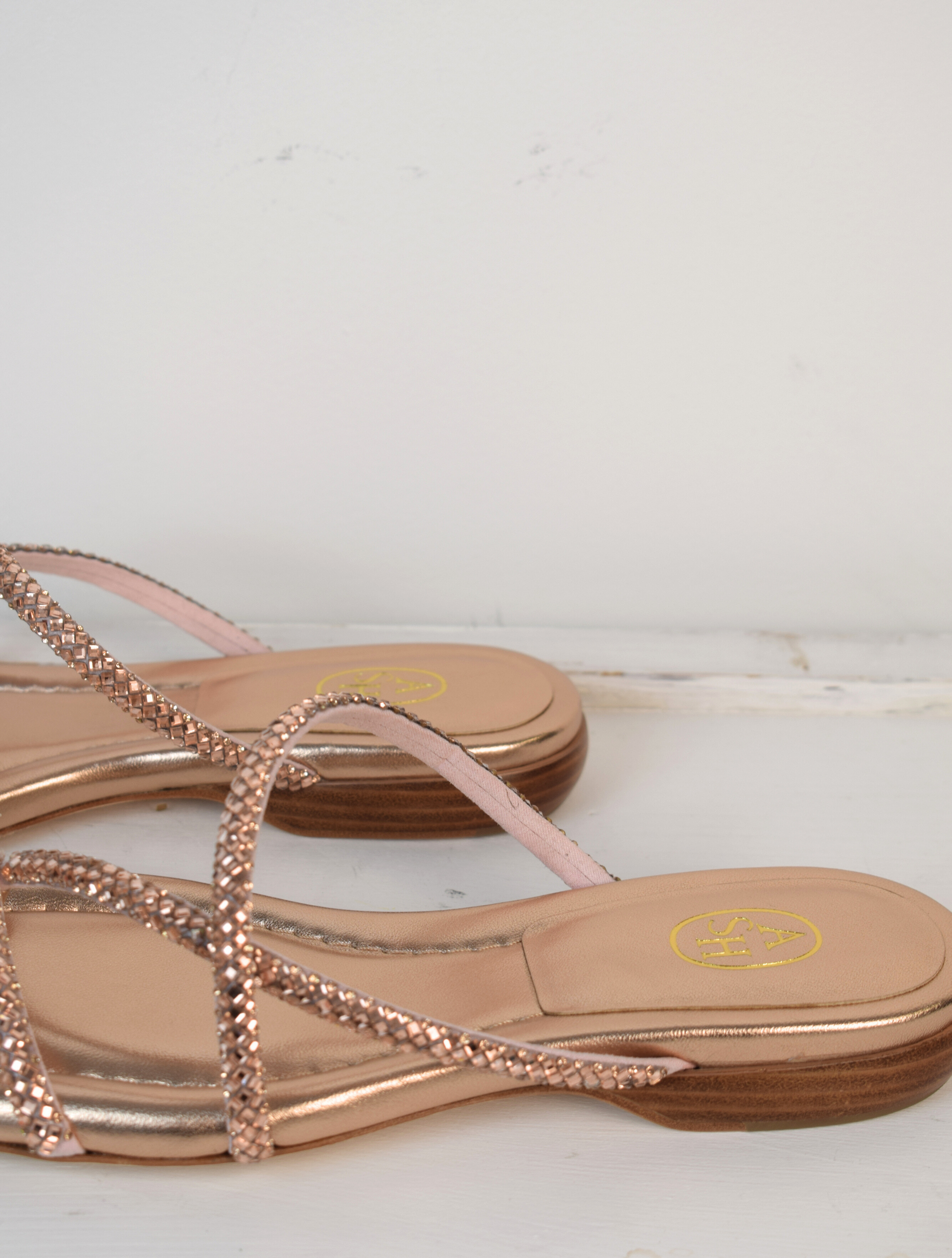 Slider style sandal in a rose gold colour with dominates on the top