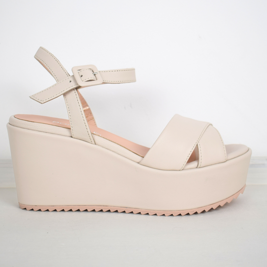 A flat pale pink sandal with large platform and ankle strap 