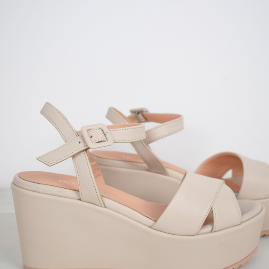 A flat pale pink sandal with large platform and ankle strap 