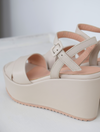 A flat pale pink sandal with large platform and ankle strap 