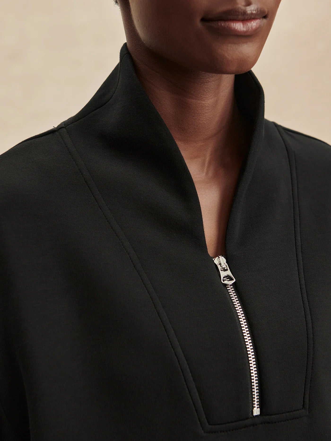 Quarter zip and slightly cropped black sweat top with shawl collar and V neckline from varley close up