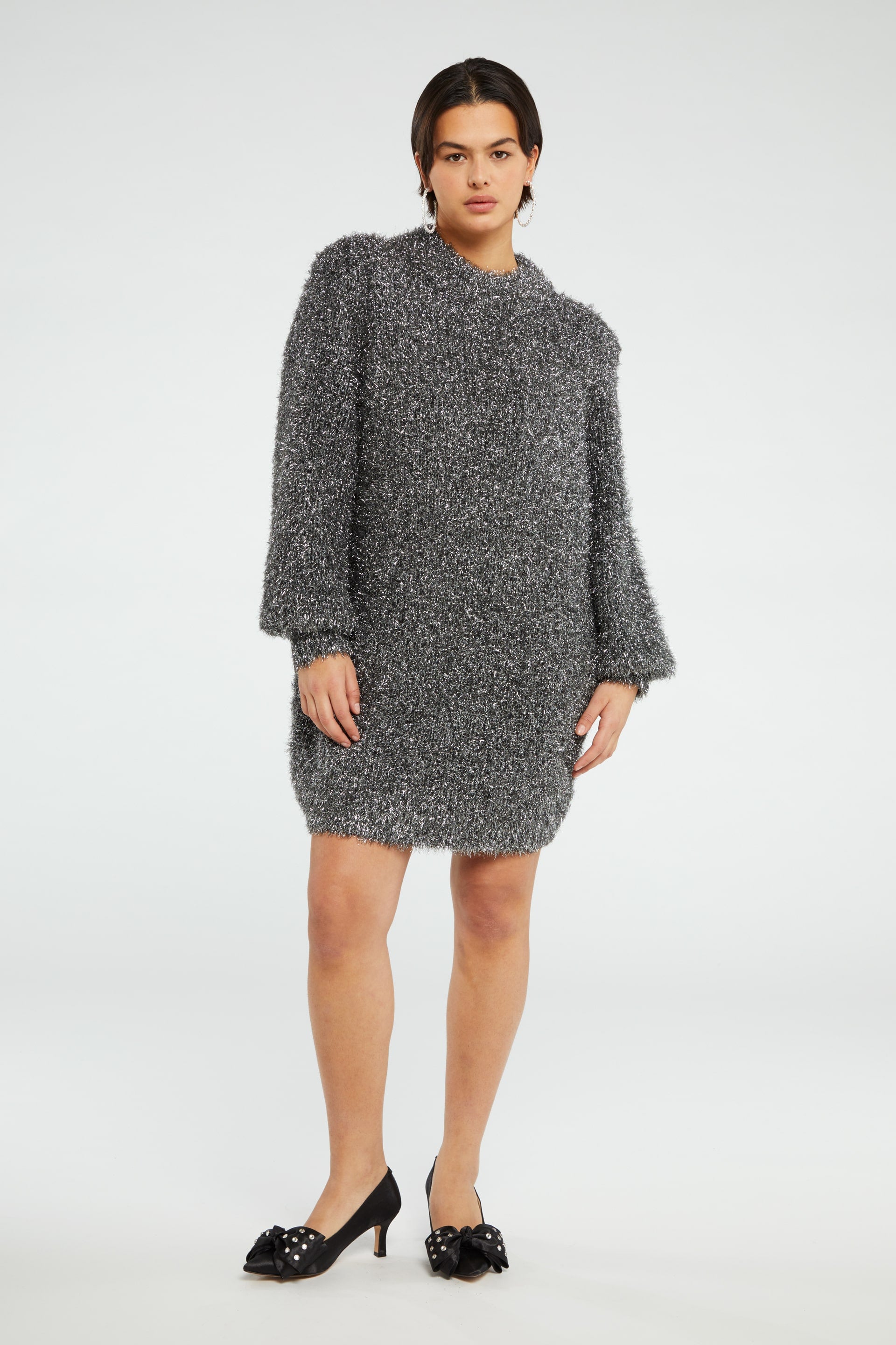 Chunky knit silver tinsel style short dress with crew neckline and long full sleeves with ribbed cuffs