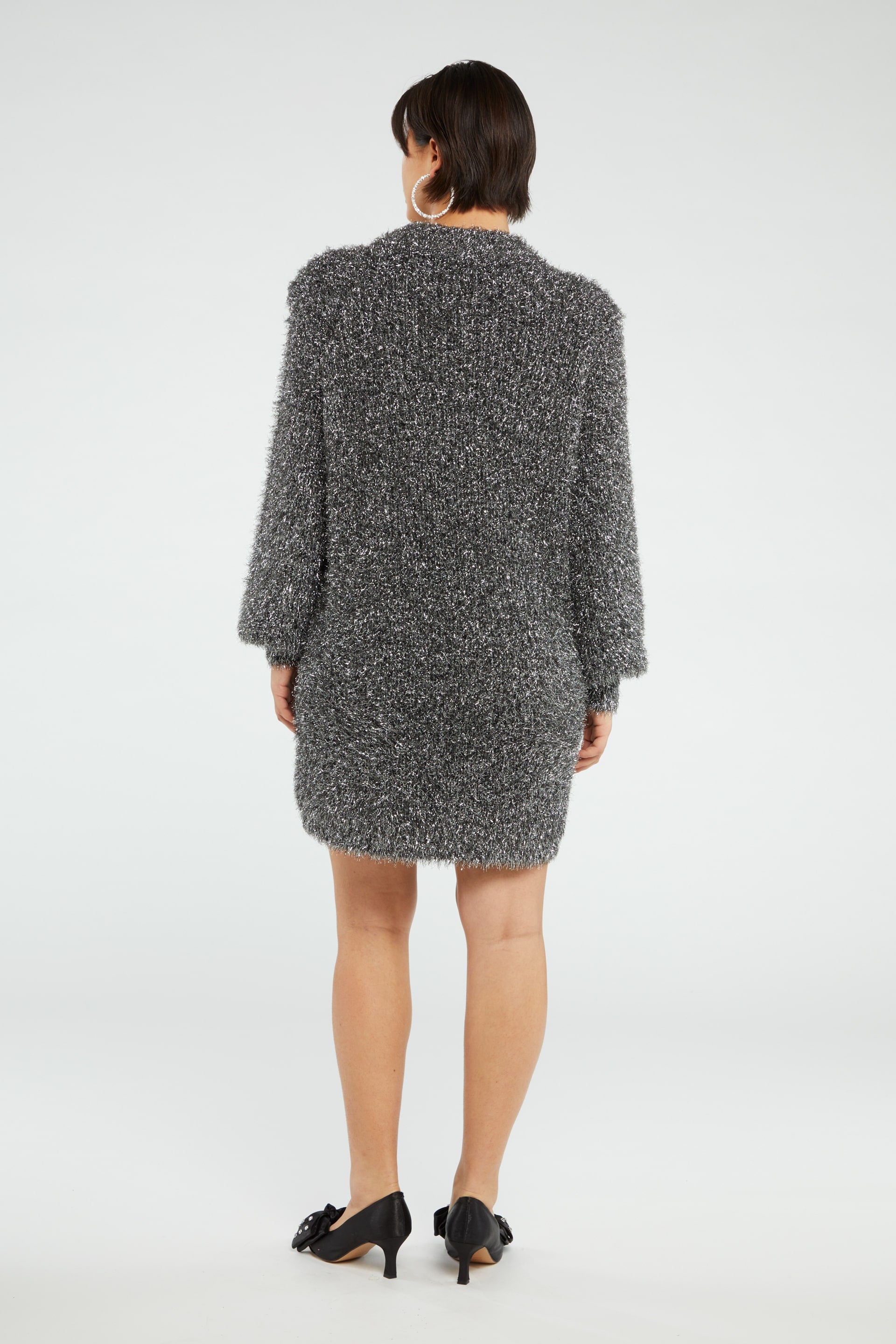 Chunky knit silver tinsel style short dress with crew neckline and long full sleeves with ribbed cuffs