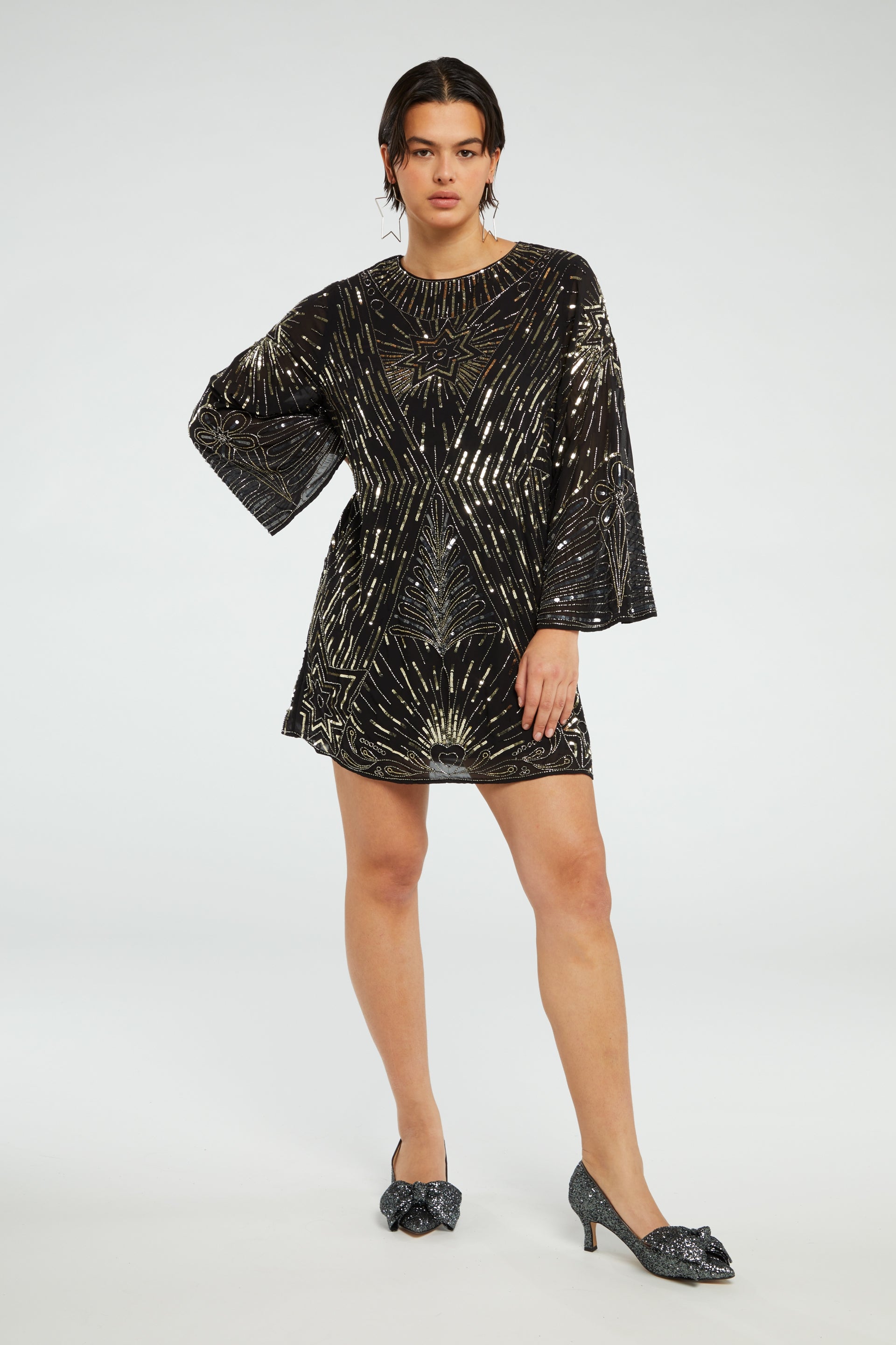 Black mini dress with long wide sleeves and gold sequin details throughout