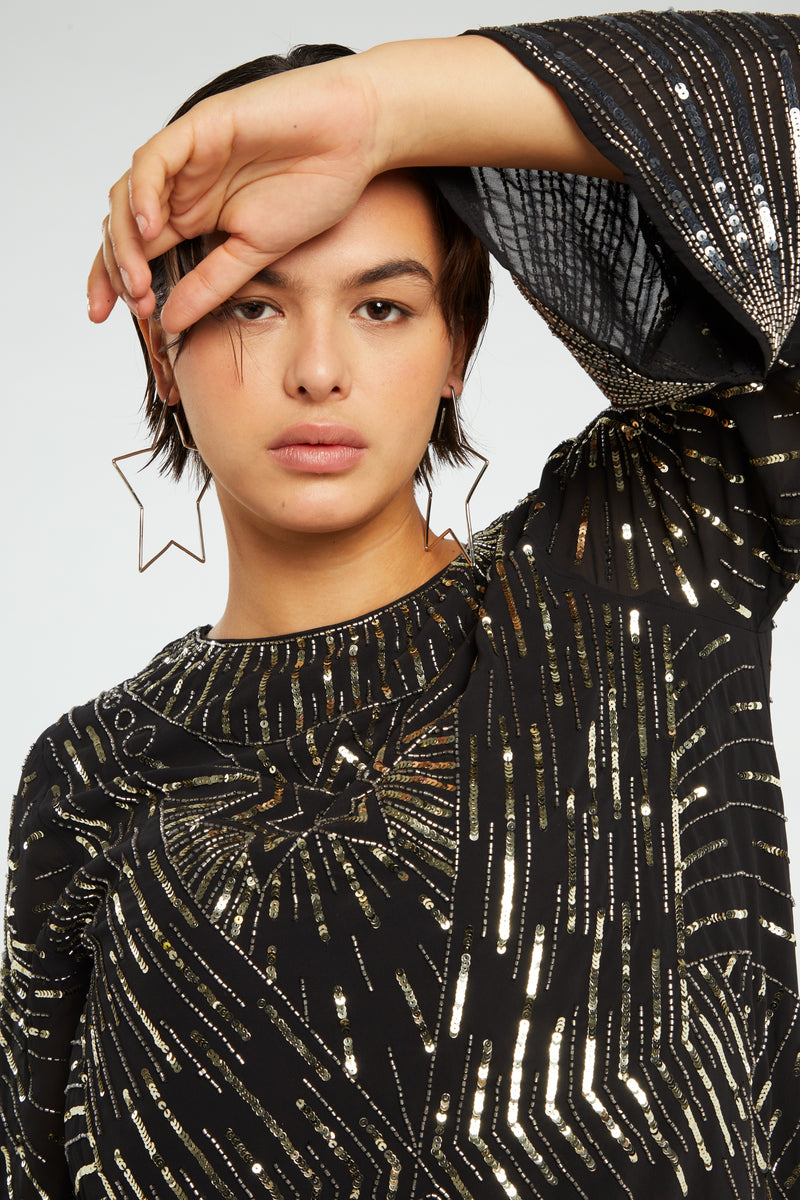 Black mini dress with long wide sleeves and gold sequin details throughout