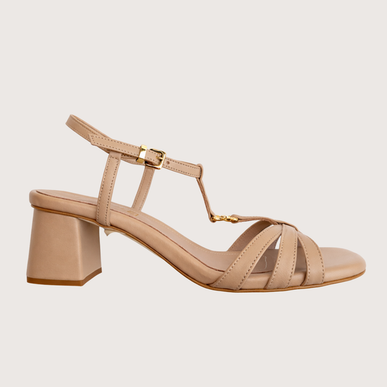 Beige sandal with a block heel on a light beige background