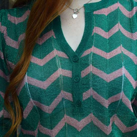 A green sparkly top with pink shevron zigzag