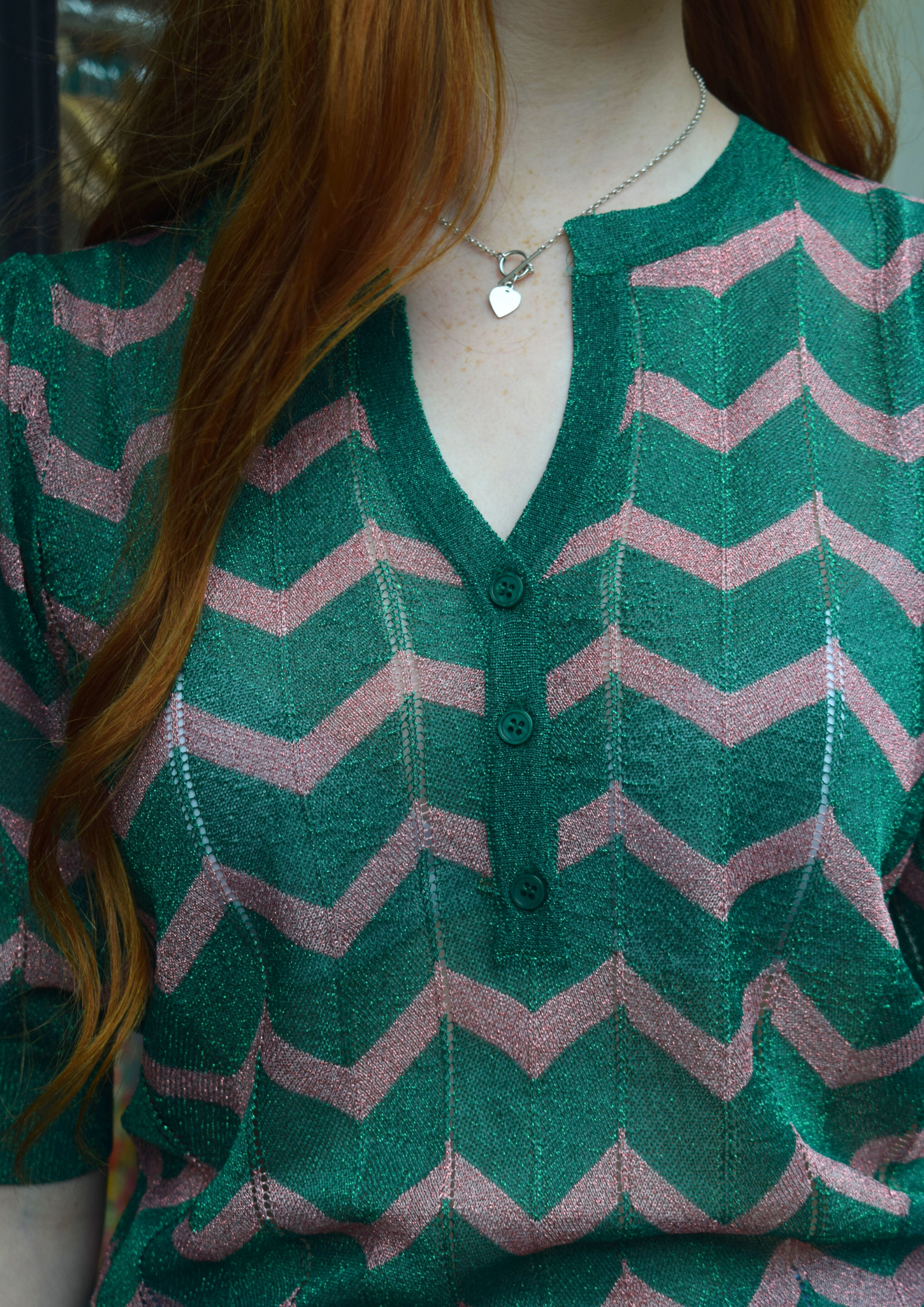 A green sparkly top with pink shevron zigzag