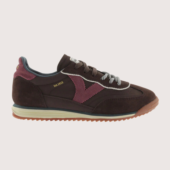 A dark brown suede and mesh sneaker with burgundy accents, featuring a cream midsole and a gum outsole, shown from a side profile on a light gray background.