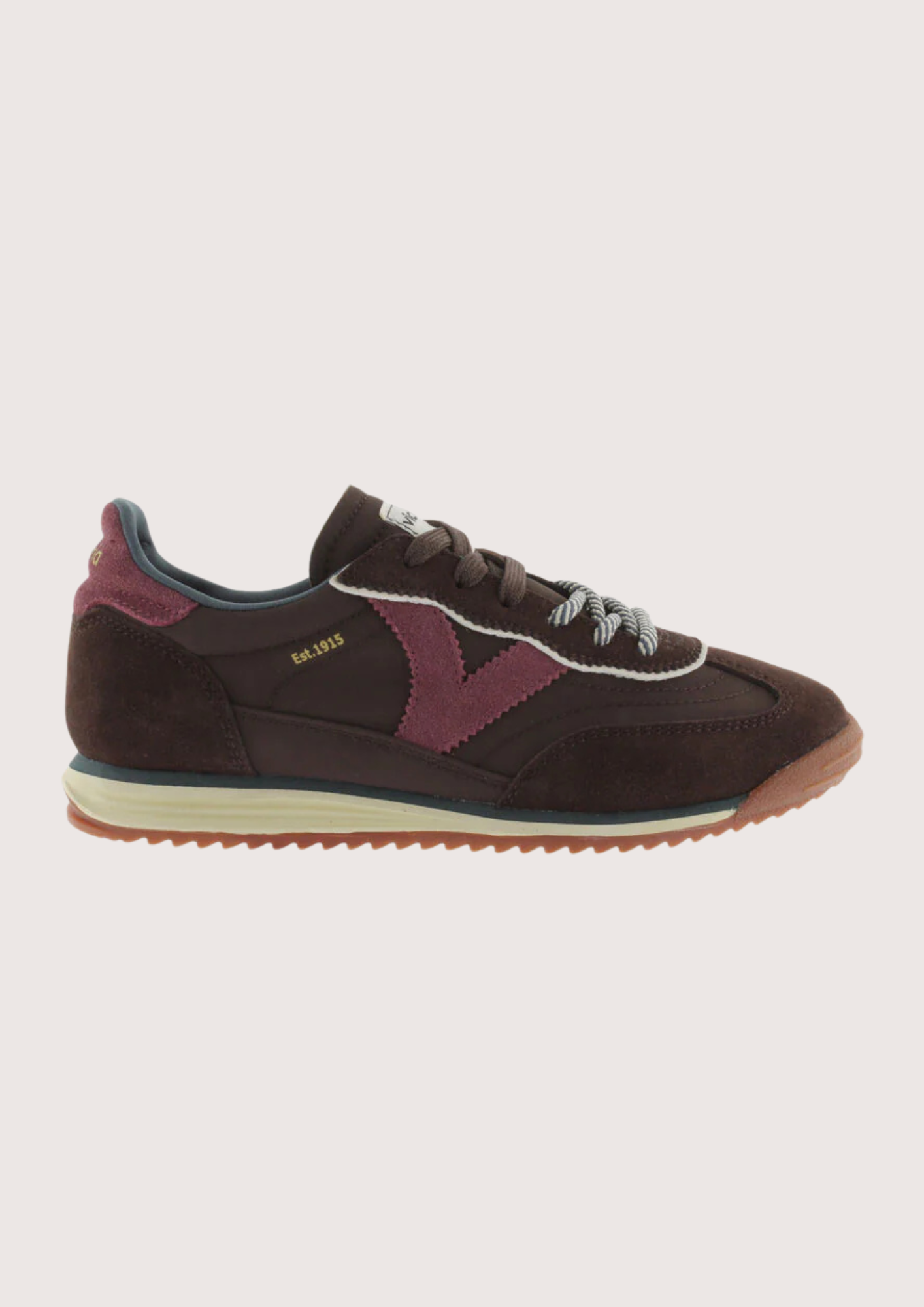 A dark brown suede and mesh sneaker with burgundy accents, featuring a cream midsole and a gum outsole, shown from a side profile on a light gray background.