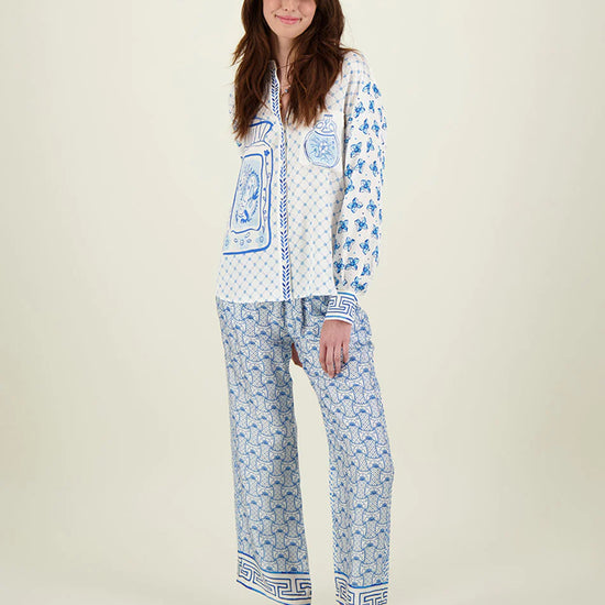 Blue and ivory patterned straight leg trousers with border hems and contrast fabric on the back 