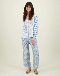 Blue and ivory patterned straight leg trousers with border hems and contrast fabric on the back 