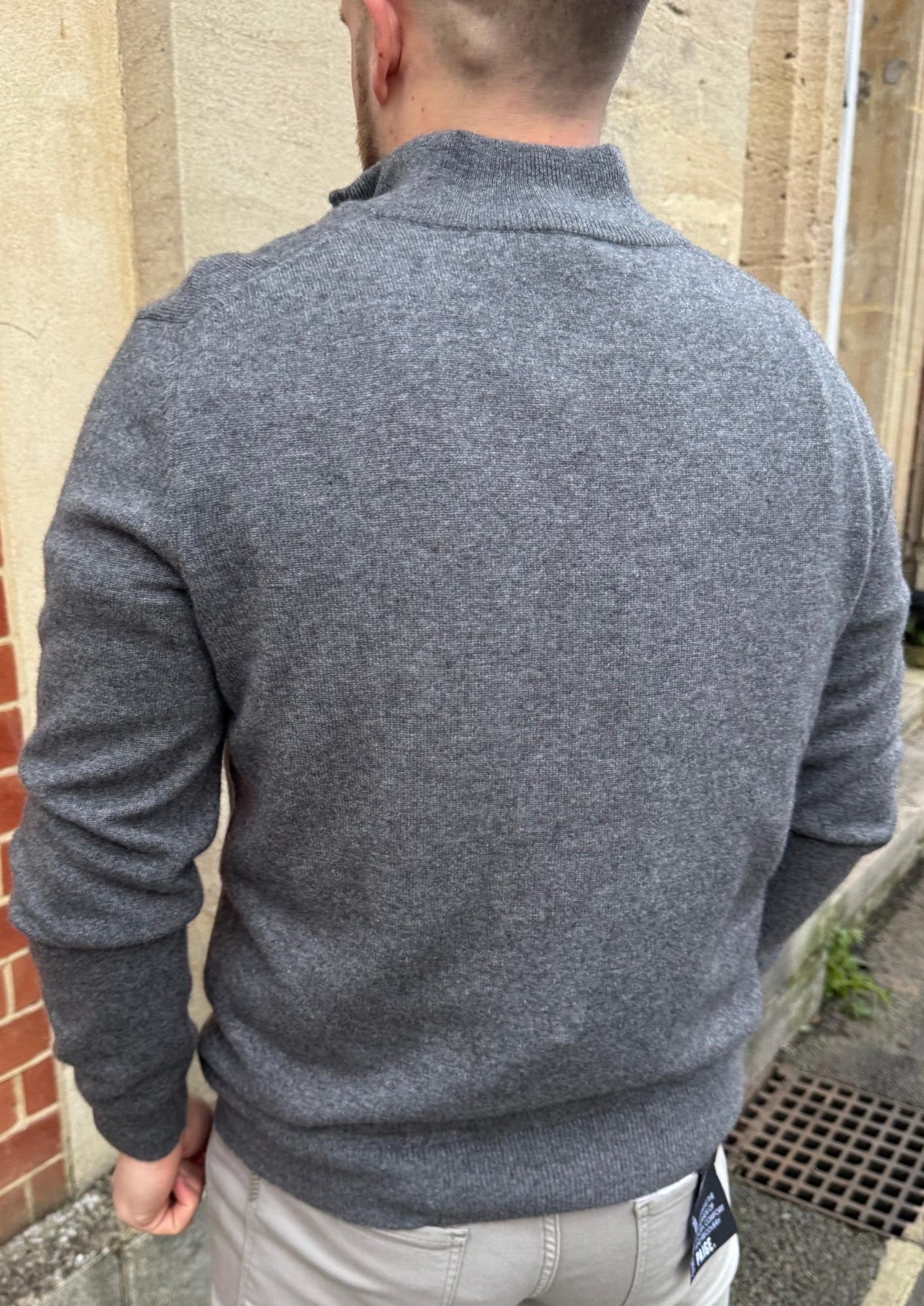 Male model wearing grey cashmere quarter zip jumper.