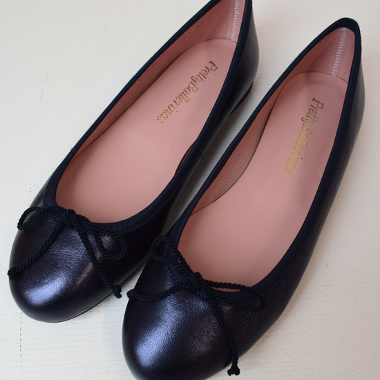 Shimmer navy blue classic round toe ballet pumps with navy thin ribbed binding and navy thin rope bow on toe