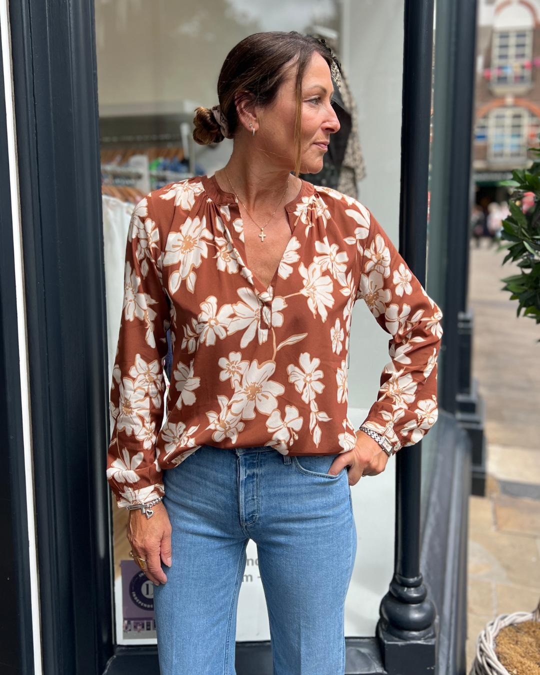 A tan top with white flowers 