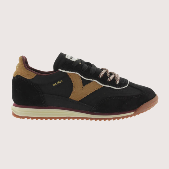 A black suede and mesh low-top sneaker with tan side panels, burgundy lining, and a cream midsole, shown from a side profile on a light gray background.