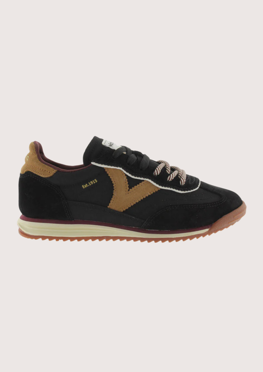 A black suede and mesh low-top sneaker with tan side panels, burgundy lining, and a cream midsole, shown from a side profile on a light gray background.
