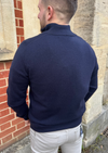 Male model wearing a navy cashmere quarter zip jumper.