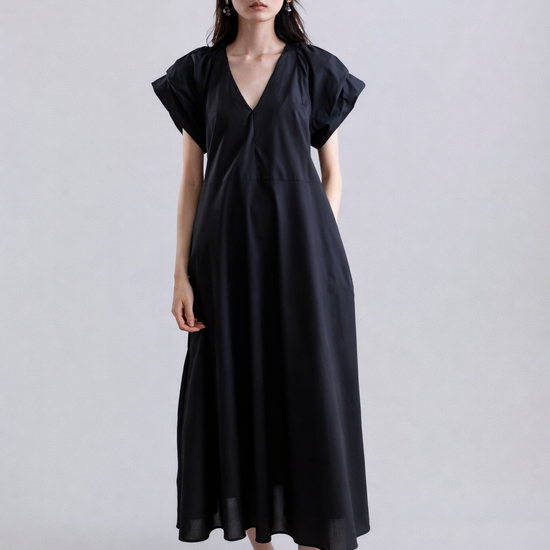 Woman wearing a black dress on a white background