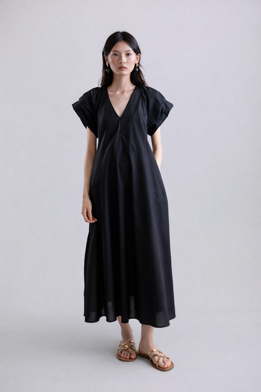 Woman wearing a black dress on a white background