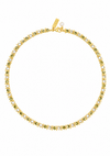 A gold tennis necklace featuring small green gemstones and clear stones, displayed on a clean white background. A gold tag is attached near the clasp.