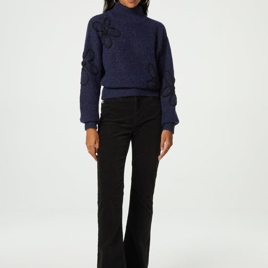 Navy turtleneck jumper with black knitted floral details