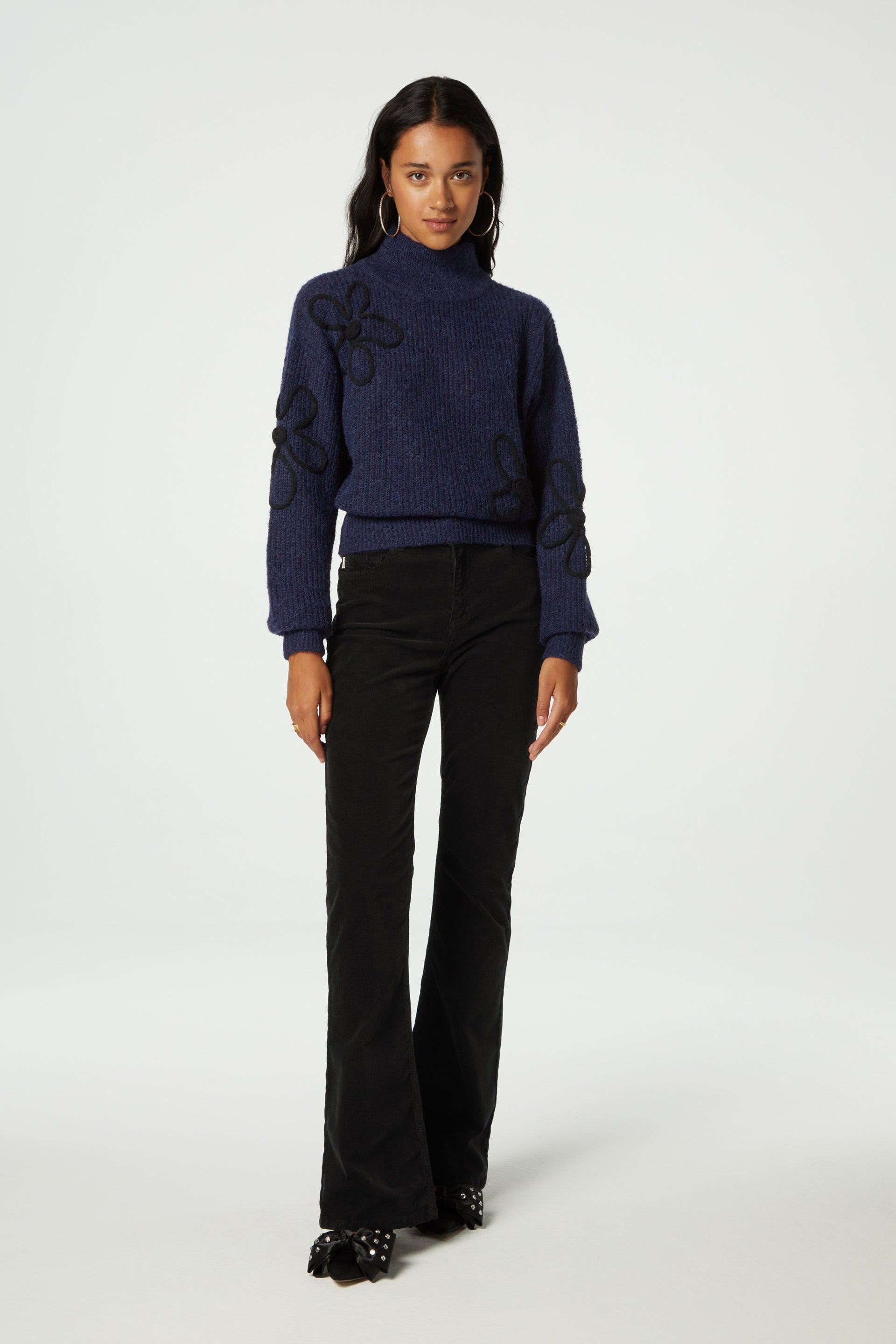 Navy turtleneck jumper with black knitted floral details