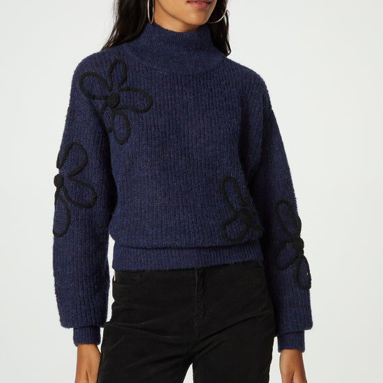 Navy turtleneck jumper with black knitted floral details